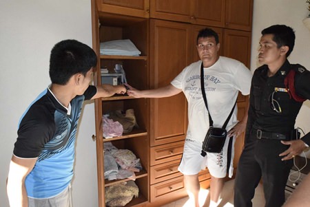 Yevgeniy Gaponchuk points out to police the half empty safe.